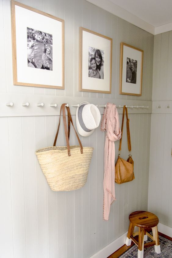 Items hanging on wooden pegs that are on the wall