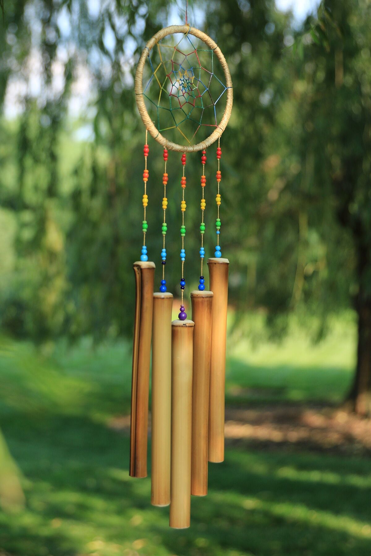A dream catcher with wooden wind chimes
