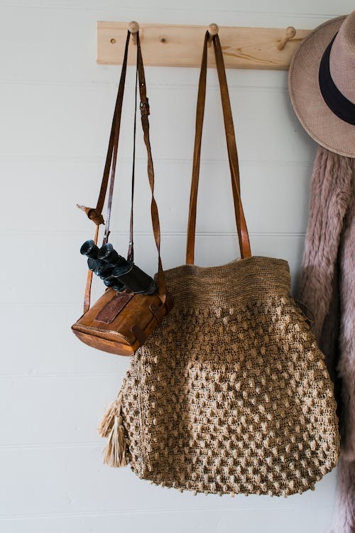 Wooden wall rack with bags hanging 
